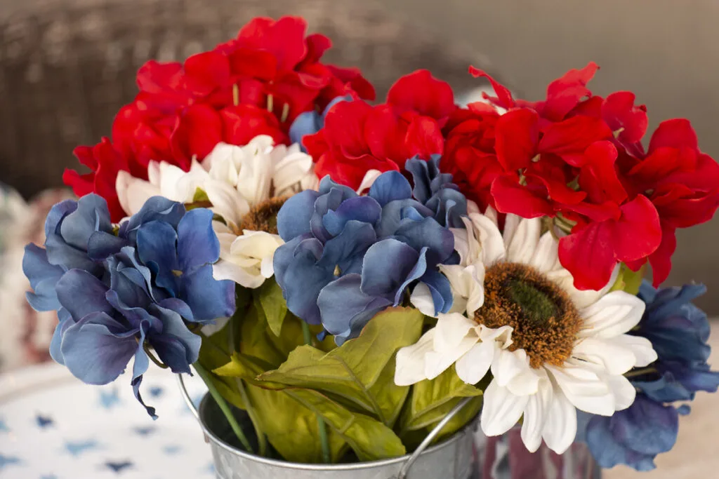 Red white and blue artificial flowers from Michaels used as a centerpiece on a patriotic table