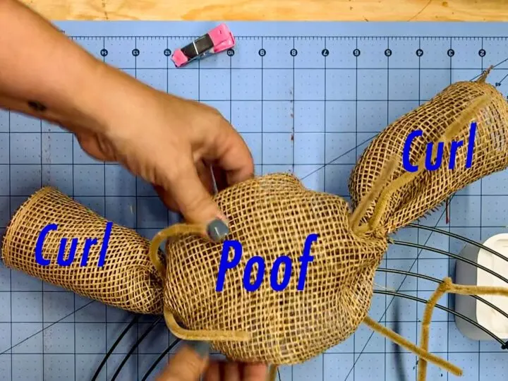 Parts of the curl and poof wreath made of rolled poly deco mesh (two mesh curls on the end surrounding a larger poof in the middle).