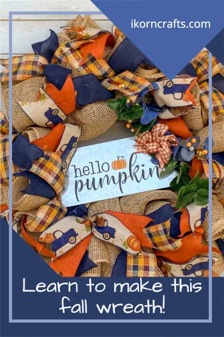 Fall wreath with poly-burlap-mesh decorated with blue, orange, and tan ribbons (including one with a blue truck with a bed of pumpkins). Includes a metal hello pumpkin sign.