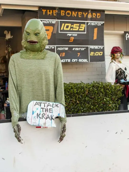 Mannequin wearing a Creature from the Black Lagoon holding a hockey coach's clipboard with an "Attack the Krak" strategy.
