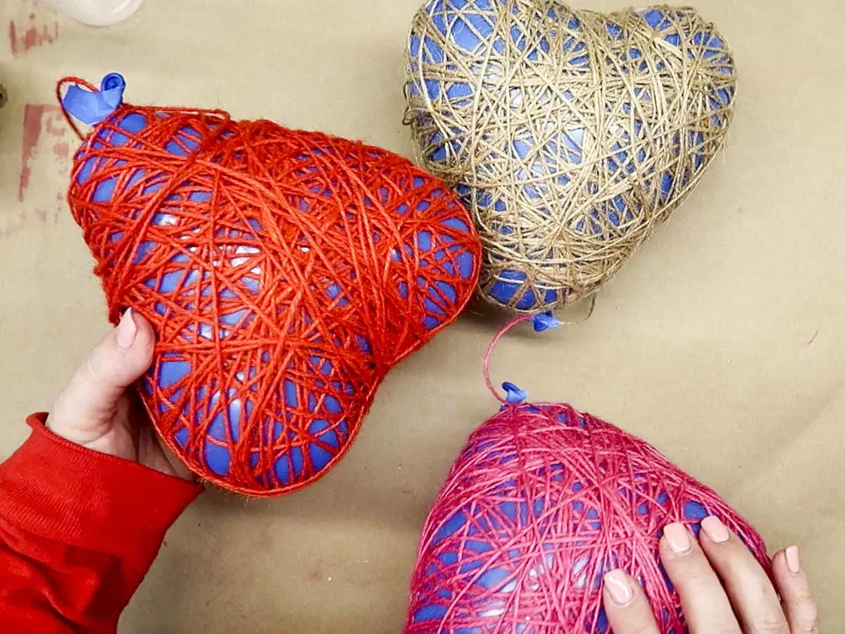 Three heart-shaped balloons covered in dry twine.