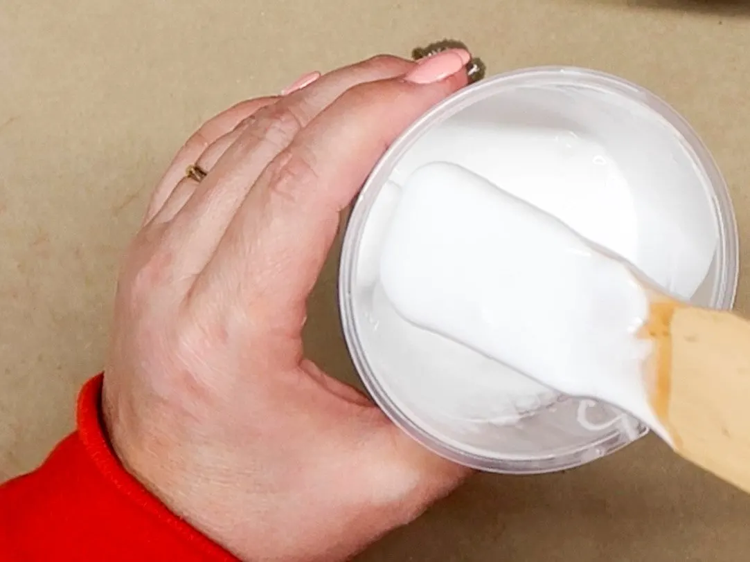 Stir stick covered in glue after mixing a cup of Aleene's Tacky Glue with water to thin the mixture.