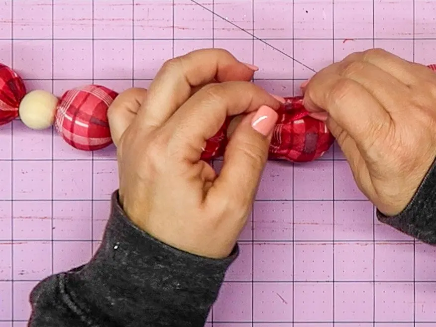 Hands covering up the ball with the scarf.